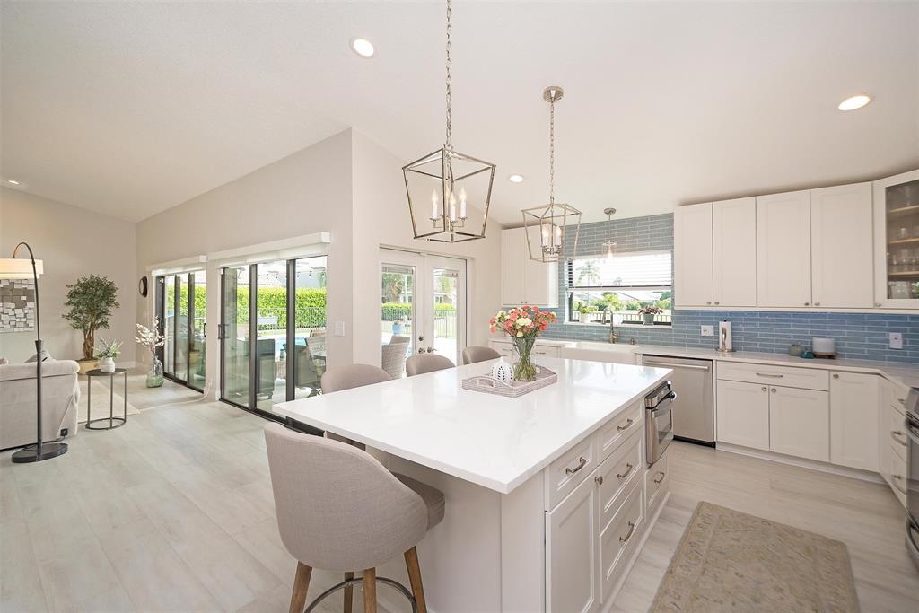 7810 Northwest 87th Avenue Tamarac, FL 33321 - Photo 8 of 21 a kitchen with center island and windows