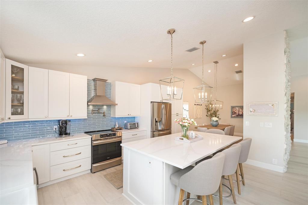 7810 Northwest 87th Avenue Tamarac, FL 33321 - Photo 9 of 21 a kitchen with stainless steel appliances kitchen island granite countertop a sink and cabinets