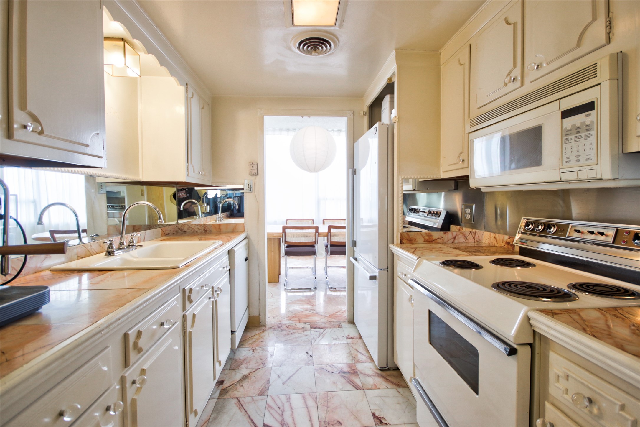 2701 Westheimer Road, Unit 7H Houston, TX 77098 - Photo 13 of 21 a kitchen with a sink stove top oven and cabinets