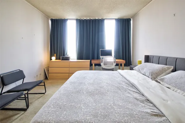a bedroom with bed and window