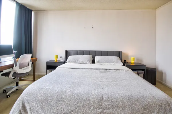 a bedroom with a bed and chair