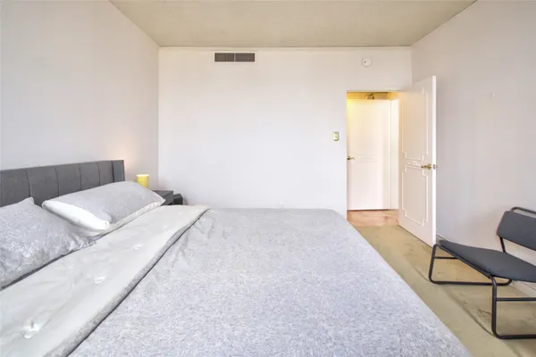 a bedroom with a bed and a chair