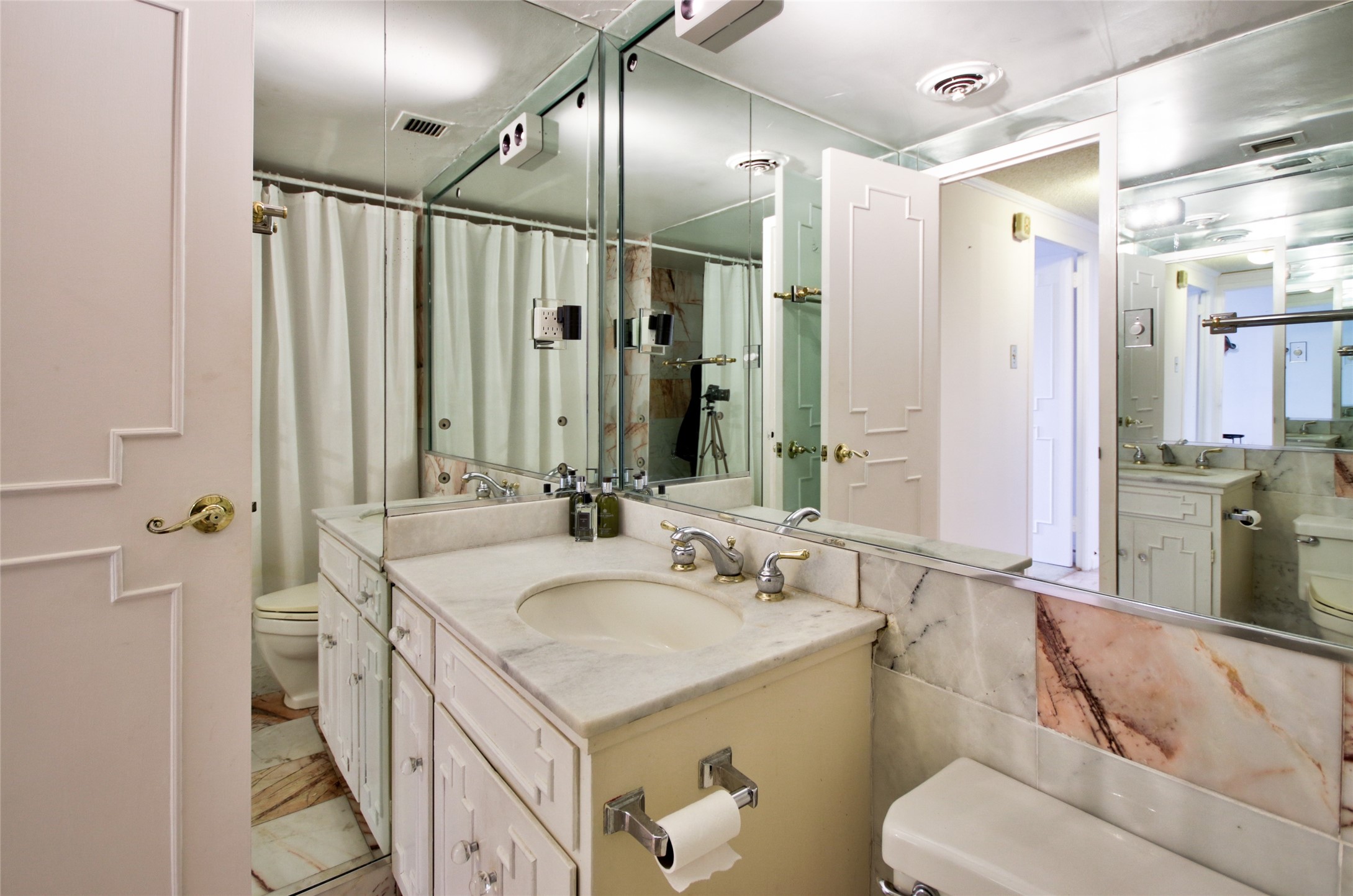 2701 Westheimer Road, Unit 7H Houston, TX 77098 - Photo 20 of 21 a bathroom with a double vanity sink mirror and toilet