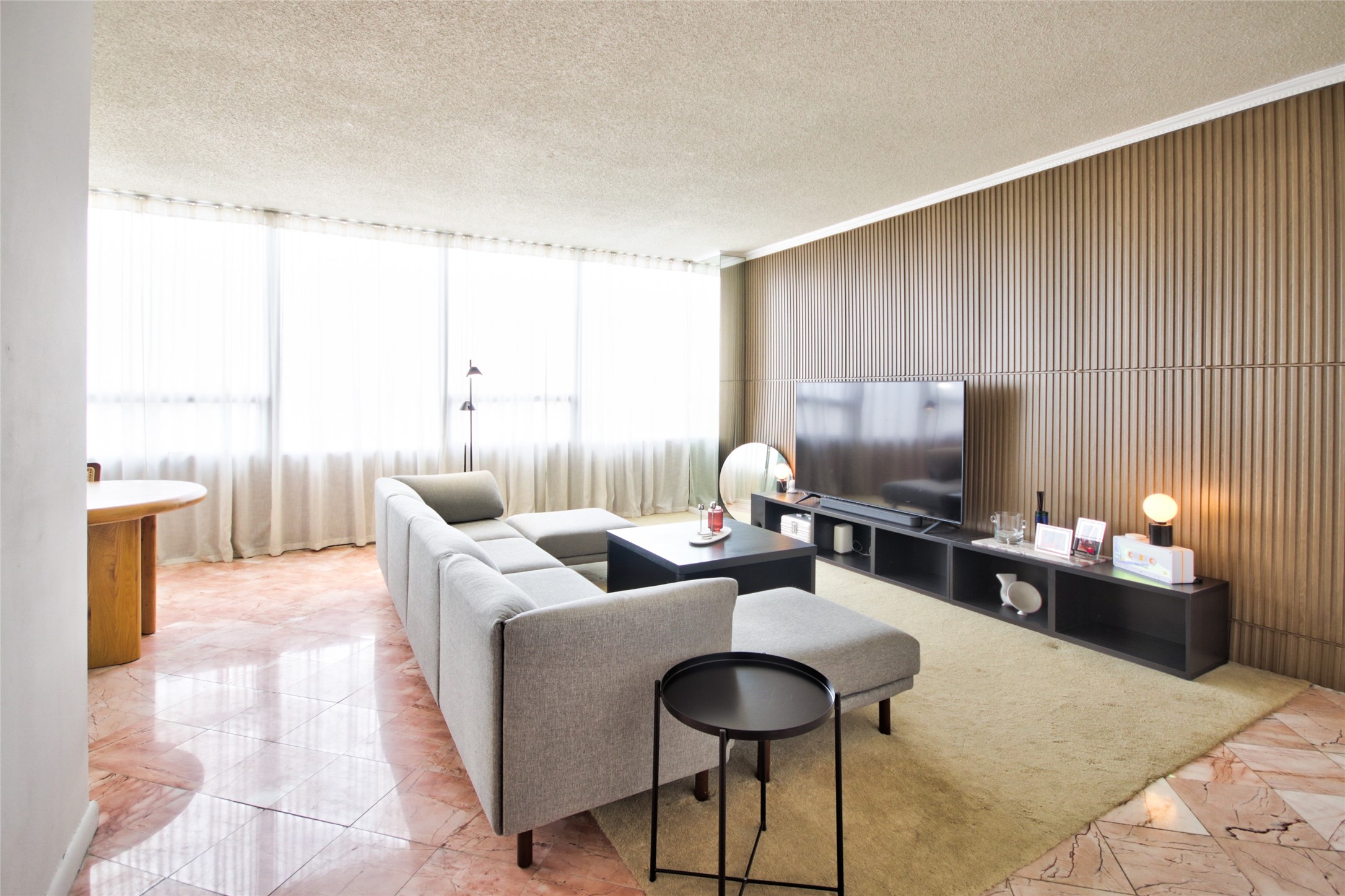 2701 Westheimer Road, Unit 7H Houston, TX 77098 - Photo 2 of 21 a living room with furniture a flat screen tv and a large window