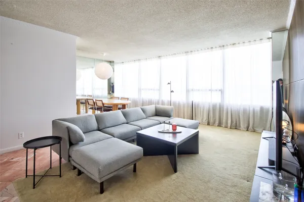 a living room with furniture and a large window