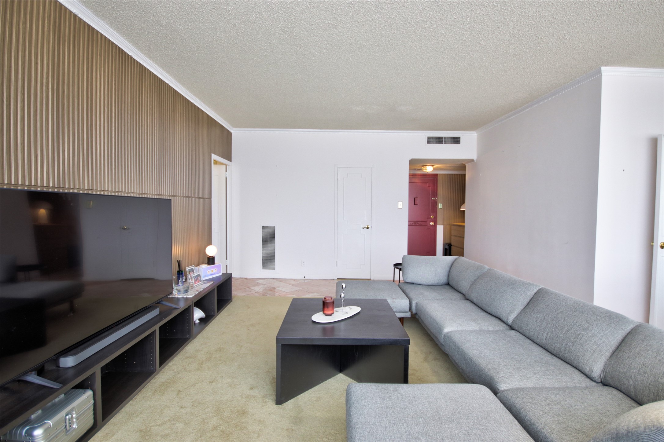 2701 Westheimer Road, Unit 7H Houston, TX 77098 - Photo 5 of 21 a living room with furniture and a flat screen tv