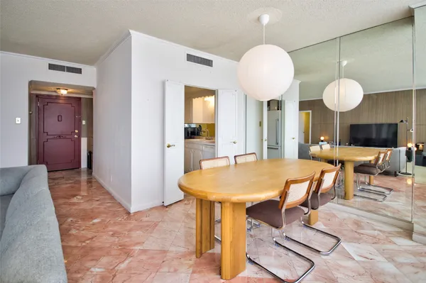 a living room with furniture a table and chairs