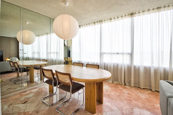 a view of a dining room with furniture and a chandelier