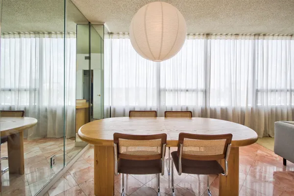 a view of a dining room with furniture and a window