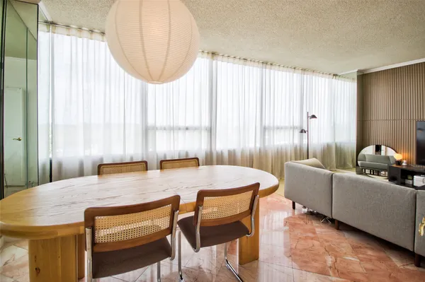 a view of a dining room with furniture and a window