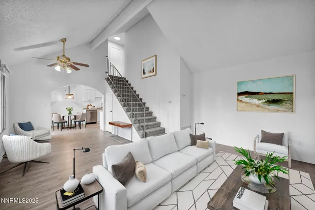a living room with furniture and wooden floor