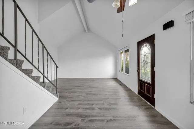 a kitchen with granite countertop a sink stove and refrigerator