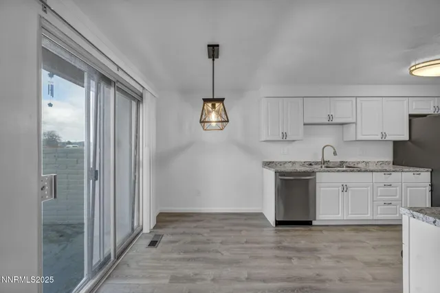 a kitchen with stainless steel appliances granite countertop a stove top oven a sink and a granite counter tops