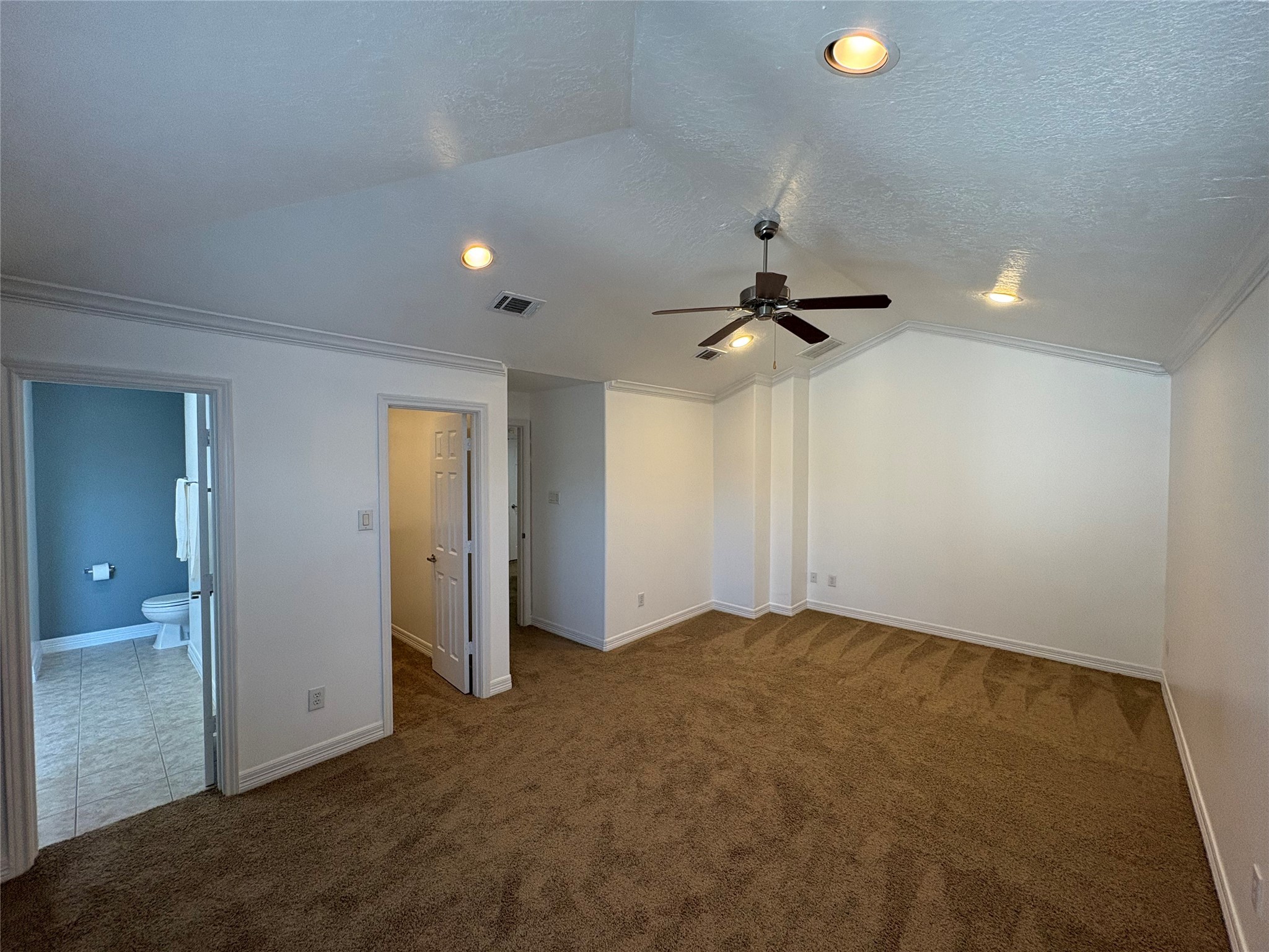 3710 Sherwood Lane, Unit 102 Houston, TX 77092 - Photo 6 of 27 Primary Bedroom with neutral carpet, a ceiling fan, and a large window for natural light. Features an accent wall, tall ceilings and access to a closet.
