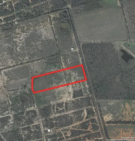 a view of a field with trees in background