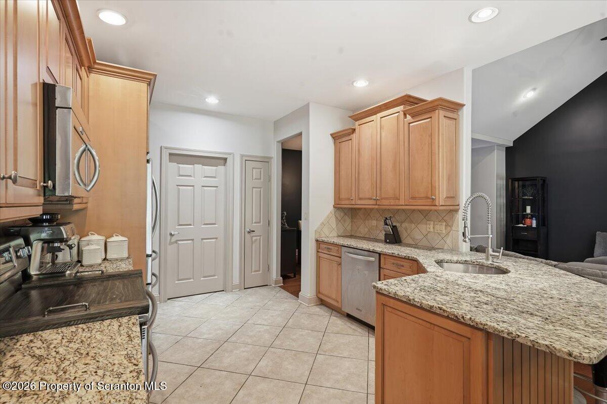 99 Hilltop Road Waverly, PA 18471 - Photo 17 of 41 a kitchen with a sink refrigerator and cabinets