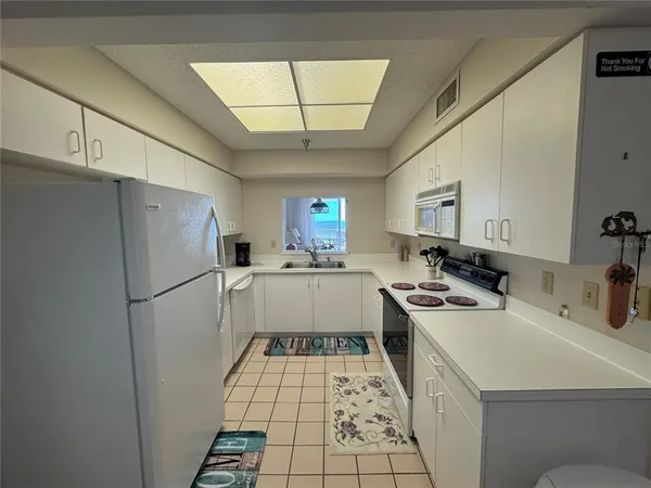 a kitchen with a refrigerator a sink dishwasher a stove a washer and dryer