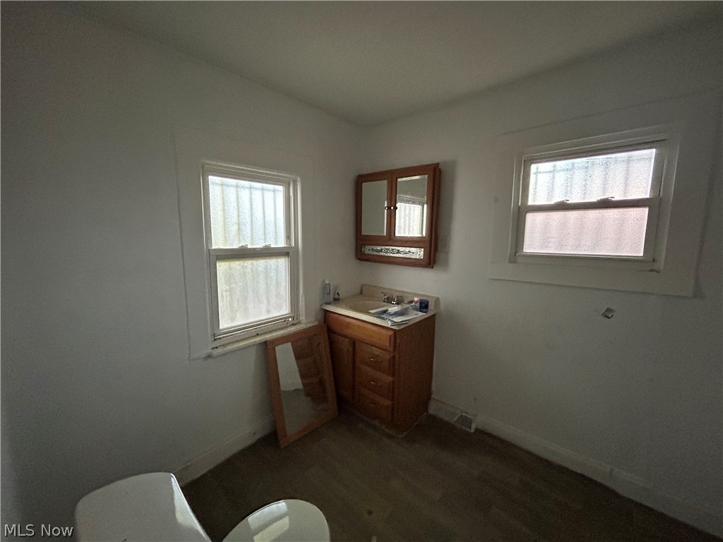 7723 Spafford Road Cleveland, OH 44105 - Photo 10 of 14 Bathroom with vanity, toilet, and hardwood / wood-style floors