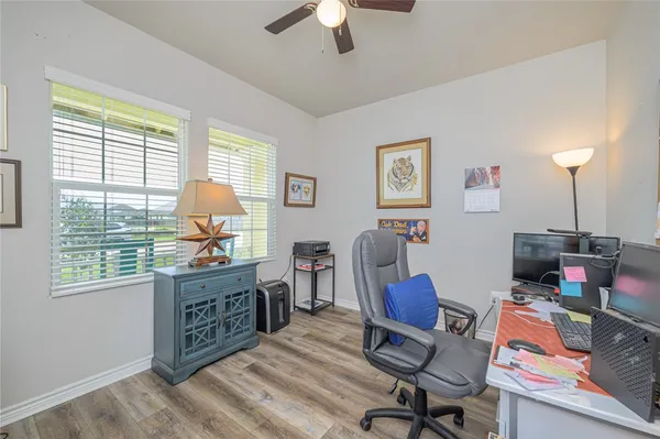 a view of a workspace with furniture and a window