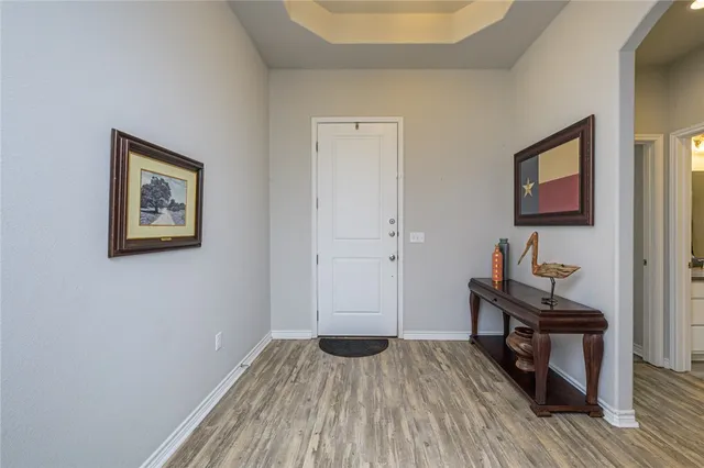 a view of a room with wooden floor and furniture
