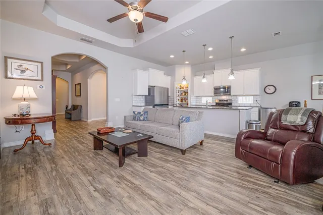 a living room with furniture and a wooden floor