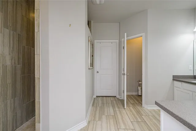 a view of a hallway with wooden floor