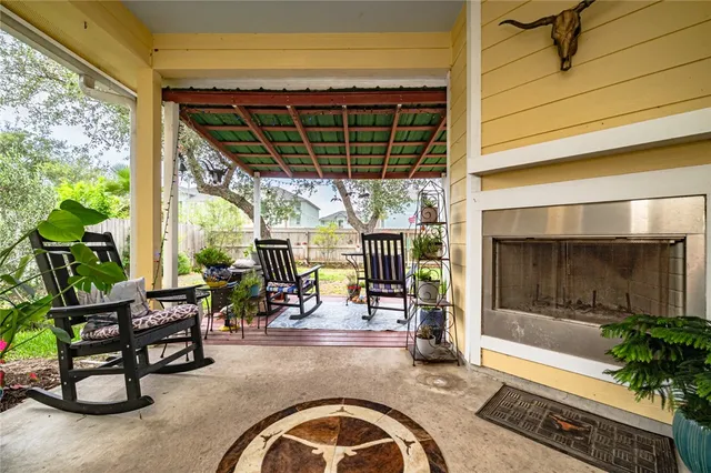 a living room with patio furniture and a fireplace