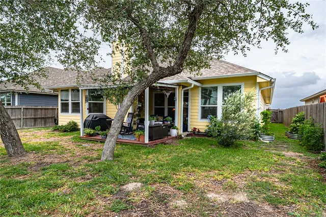 a view of a house with a yard and sitting area