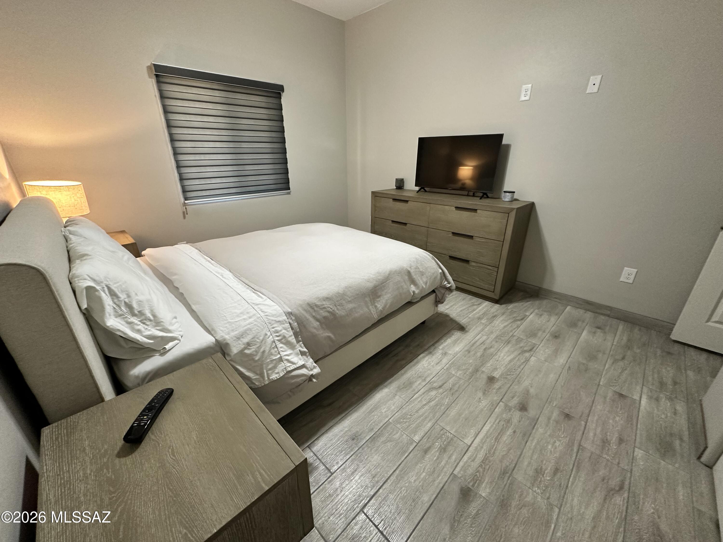 117 Ver Patria Rio Rico, AZ 85648 - Photo 8 of 28 a spacious bedroom with a bed and a flat screen tv