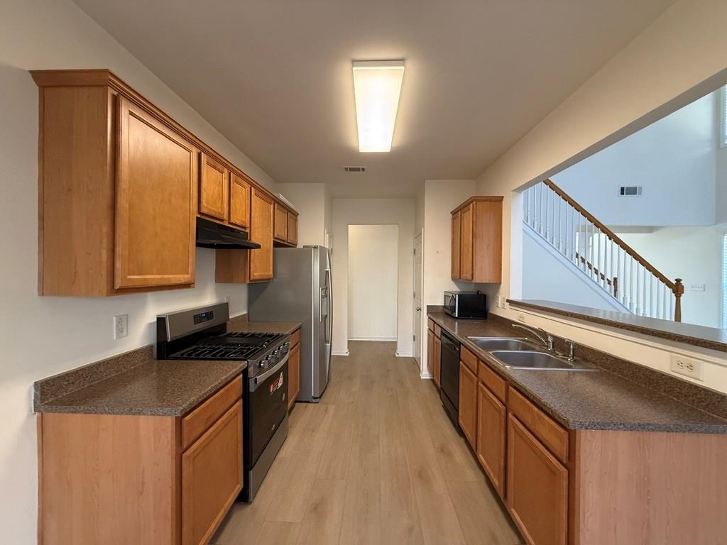 4273 Winslow Hill Court Suwanee, GA 30024 - Photo 11 of 34 a kitchen with granite countertop a sink a stove refrigerator and cabinets