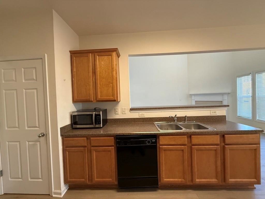 4273 Winslow Hill Court Suwanee, GA 30024 - Photo 14 of 34 a kitchen with stainless steel appliances granite countertop a sink and a stove