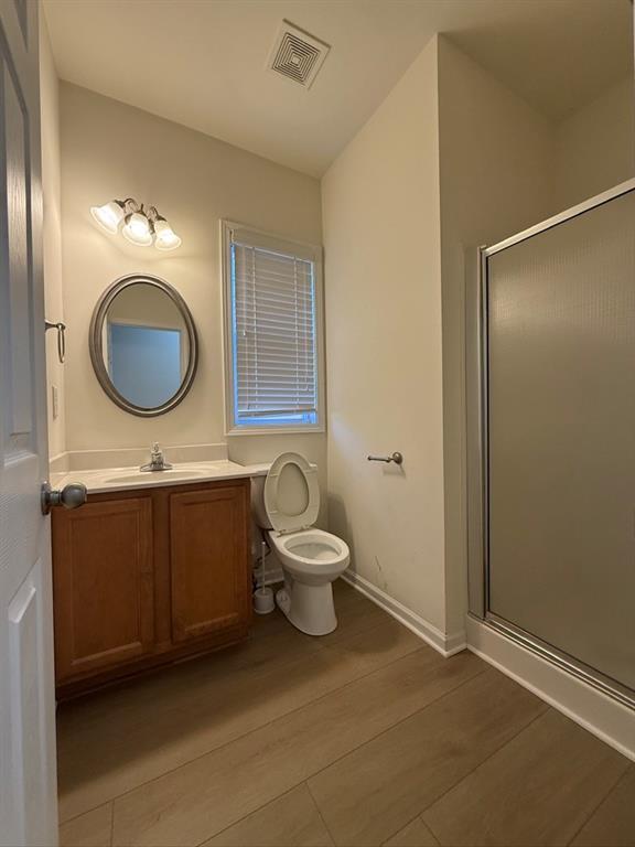 4273 Winslow Hill Court Suwanee, GA 30024 - Photo 16 of 34 a bathroom with a toilet a sink and mirror