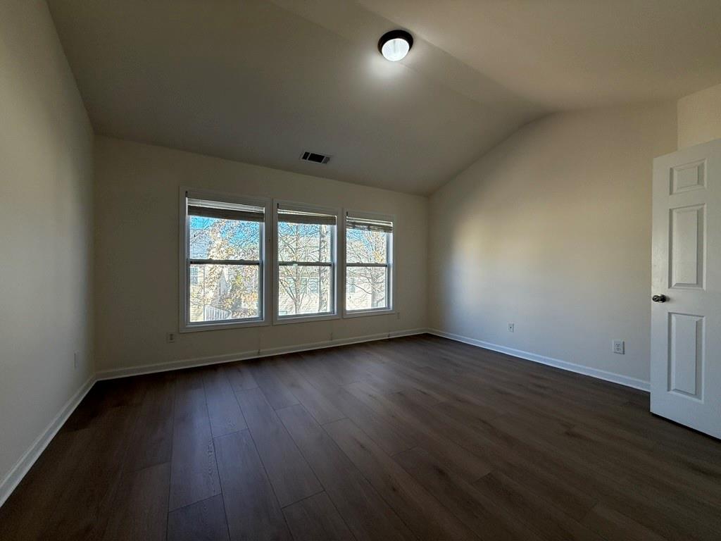 4273 Winslow Hill Court Suwanee, GA 30024 - Photo 18 of 34 an empty room with wooden floor and windows