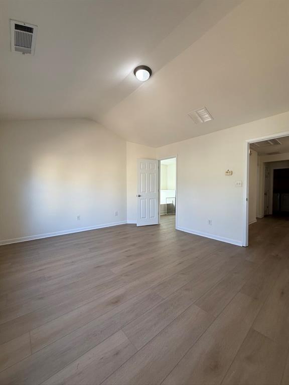 4273 Winslow Hill Court Suwanee, GA 30024 - Photo 19 of 34 an empty room with wooden floor and windows