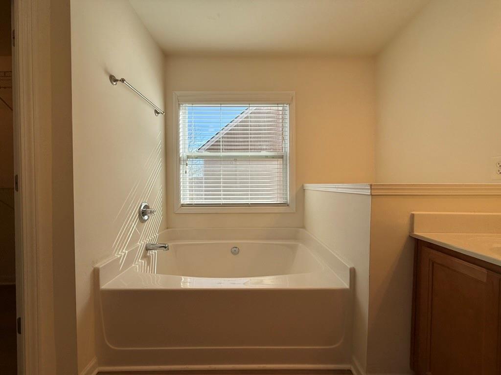 4273 Winslow Hill Court Suwanee, GA 30024 - Photo 23 of 34 a bathroom with bathtub and a window