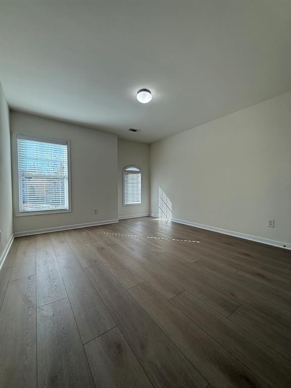 4273 Winslow Hill Court Suwanee, GA 30024 - Photo 26 of 34 an empty room with wooden floor and windows