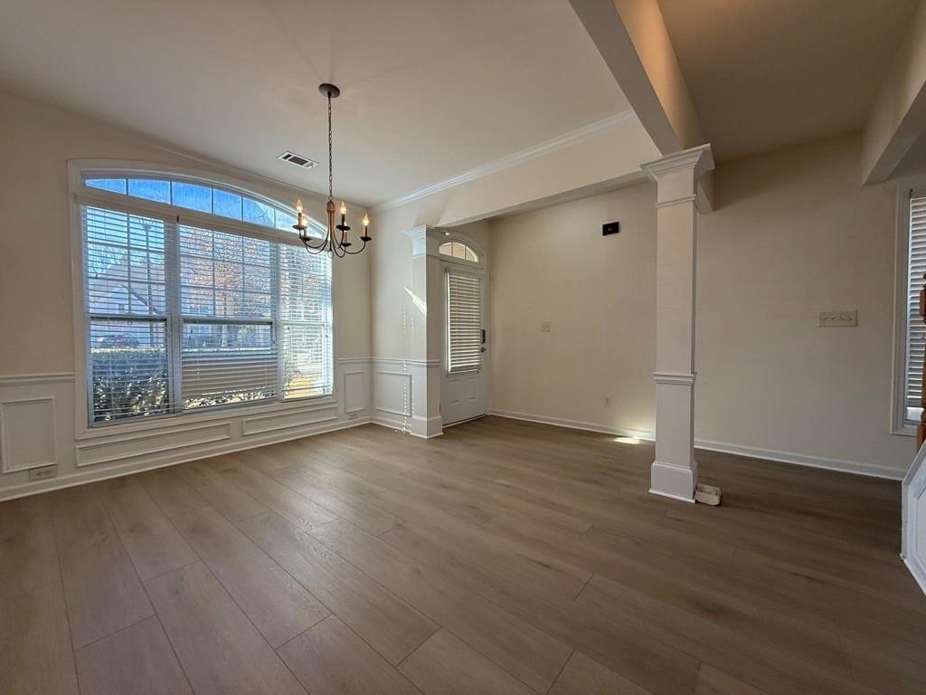 4273 Winslow Hill Court Suwanee, GA 30024 - Photo 3 of 34 a view of a room with wooden floor a ceiling fan and window