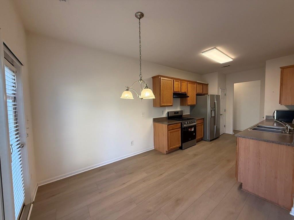 4273 Winslow Hill Court Suwanee, GA 30024 - Photo 10 of 34 a kitchen with stainless steel appliances granite countertop a sink a stove and refrigerator
