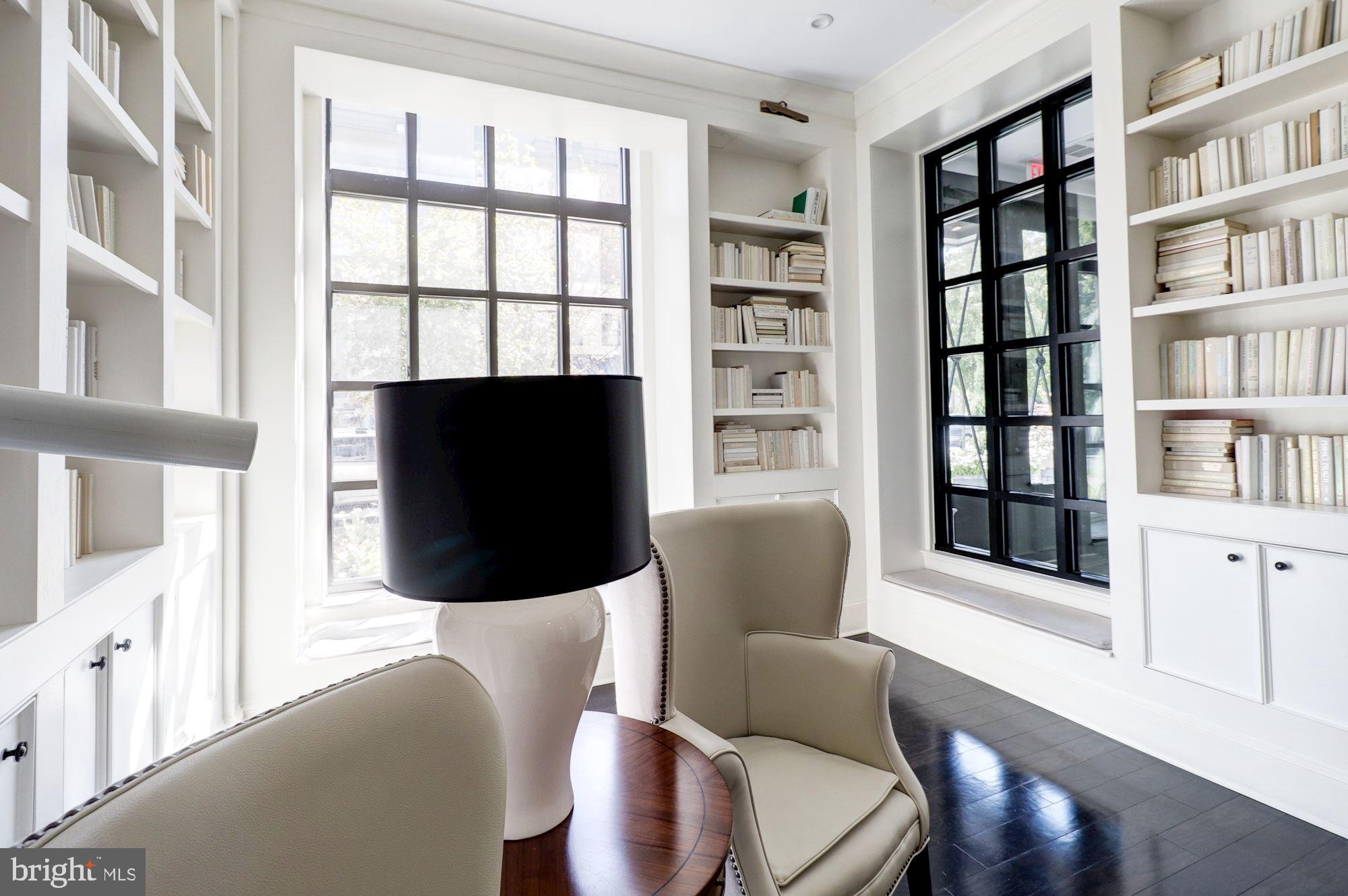 1011 M Street Northwest, Unit 702 Washington, DC 20001 - Photo 32 of 61 a living room with furniture a flat screen tv and a large window