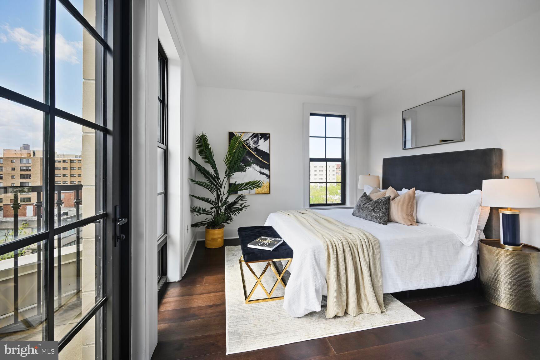 1011 M Street Northwest, Unit 702 Washington, DC 20001 - Photo 5 of 61 a bedroom with a bed and wooden floor
