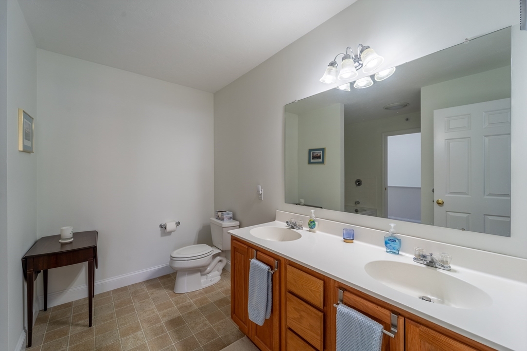 17 Village Way, Unit 17 Rutland, MA 01543 - Photo 20 of 33 a bathroom with a double vanity sink mirror and toilet