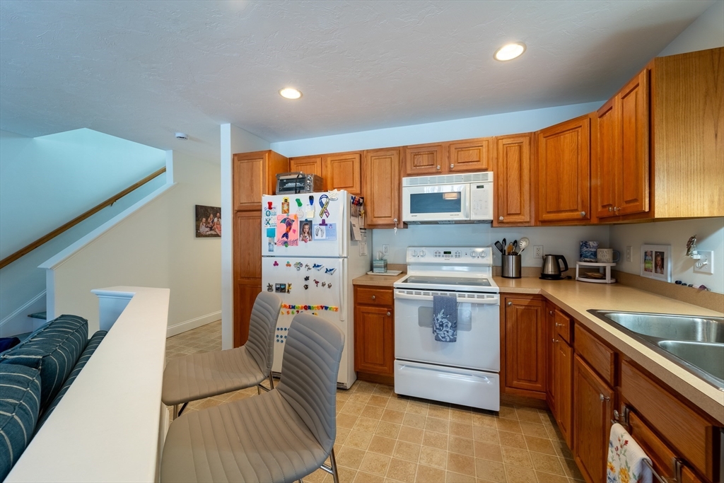 17 Village Way, Unit 17 Rutland, MA 01543 - Photo 9 of 33 a kitchen with stainless steel appliances granite countertop a stove a sink dishwasher and a refrigerator
