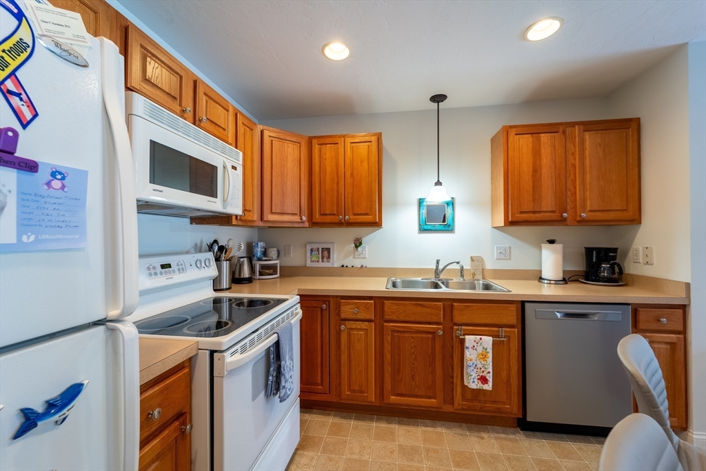 17 Village Way, Unit 17 Rutland, MA 01543 - Photo 10 of 33 a kitchen with stainless steel appliances granite countertop a sink a stove a refrigerator cabinets and a window