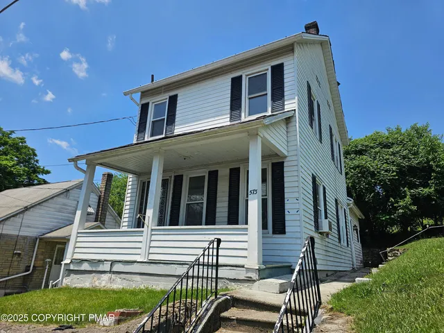a front view of a house with a porch
