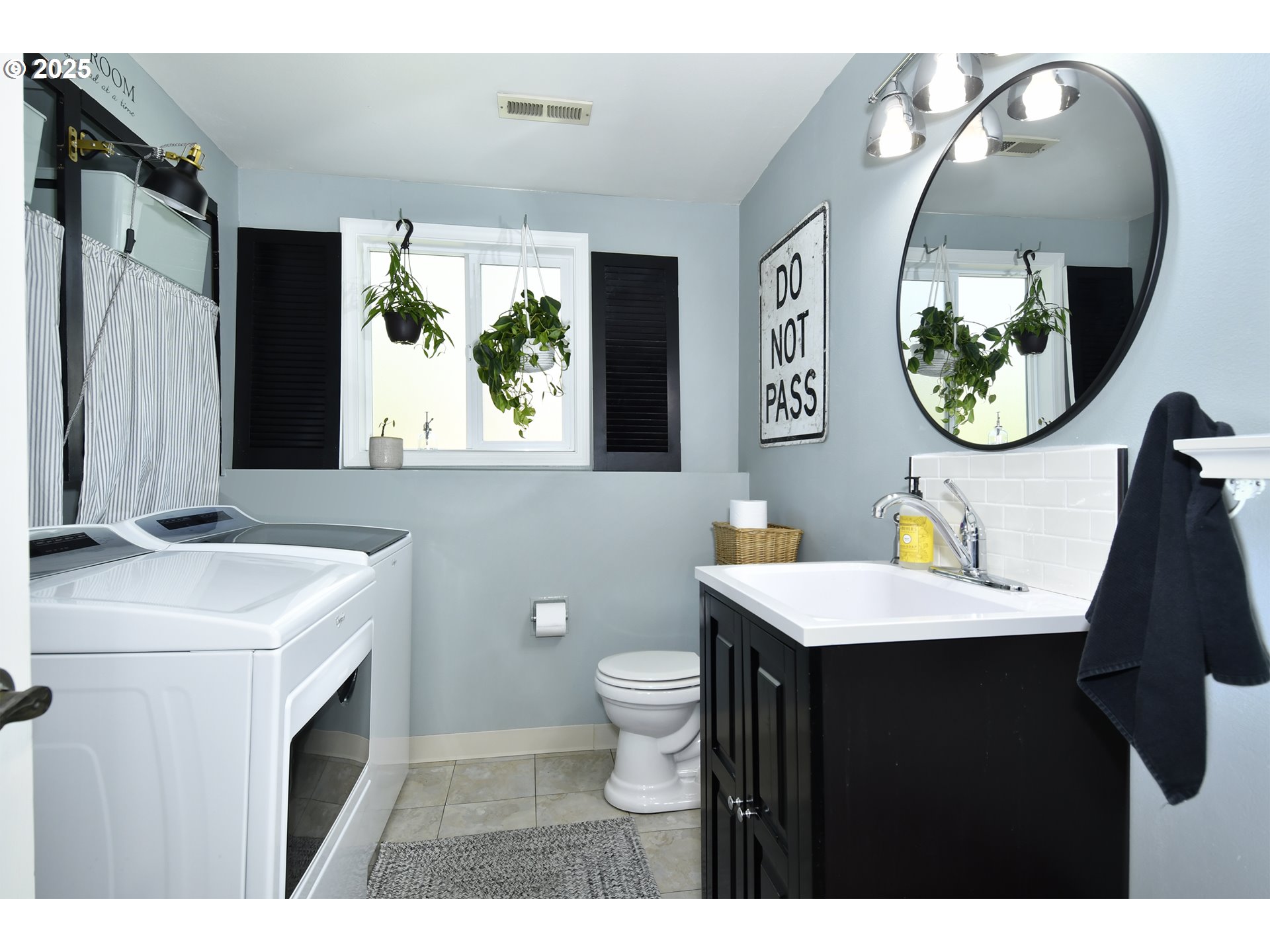 2430 Southwest Willowbrook Avenue Gresham, OR 97080 - Photo 17 of 33 a bathroom with a toilet a sink and a mirror