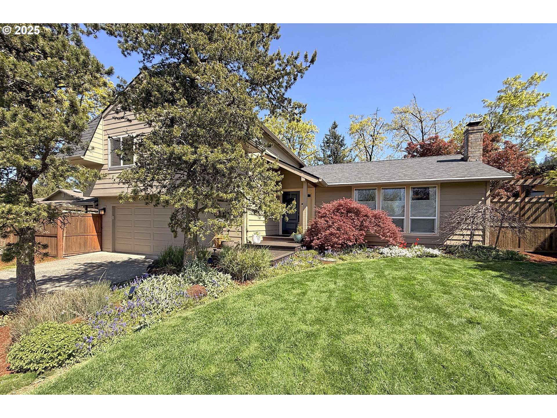 2430 Southwest Willowbrook Avenue Gresham, OR 97080 - Photo 3 of 33 a front view of a house with a garden
