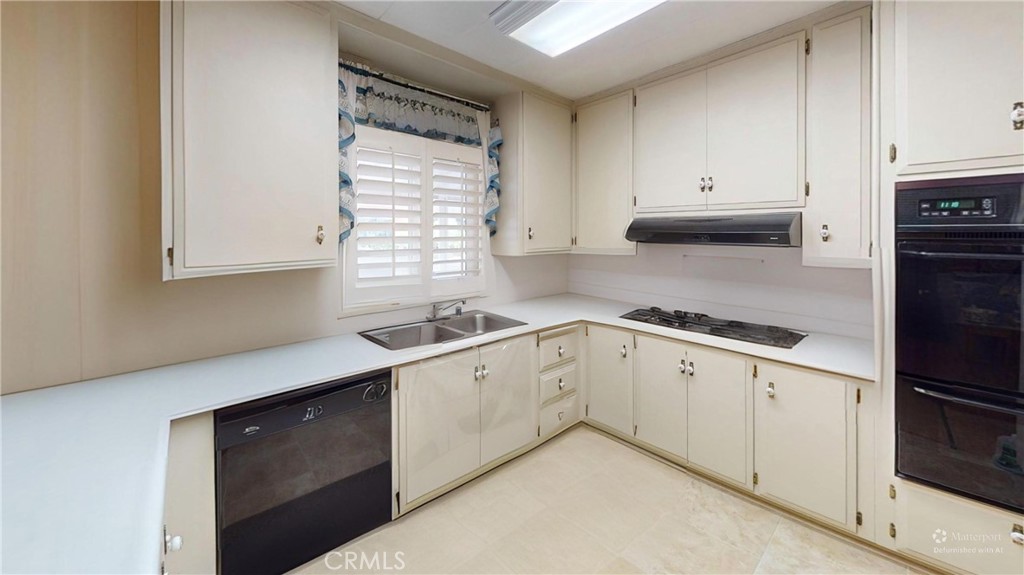14851 Jeffrey Road, Unit 117 Irvine, CA 92618 - Photo 35 of 45 a kitchen with granite countertop white cabinets and white appliances