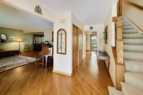 a living room with furniture a rug and a large window