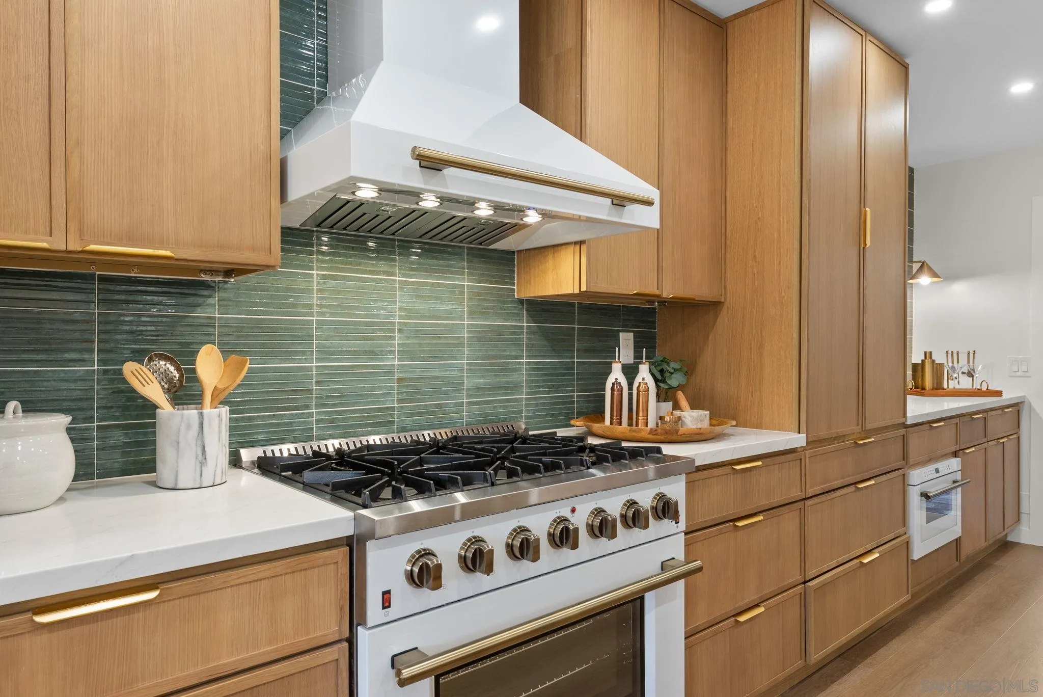 a kitchen with stove and cabinets