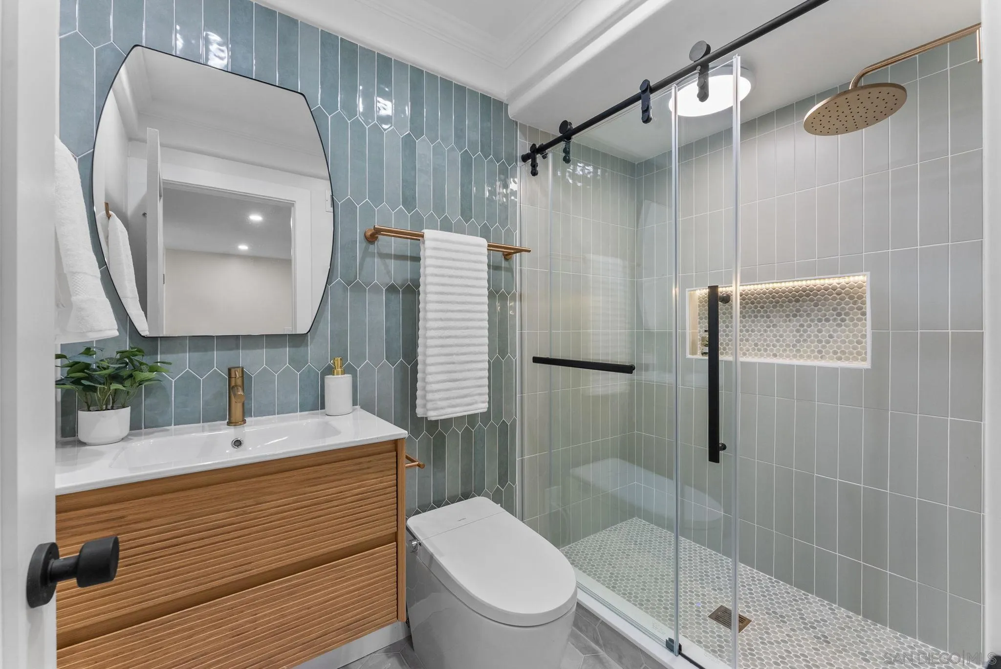 16048 Via Viajera Rancho Santa Fe, CA 92091 - Photo 16 of 46 a bathroom with a sink a toilet and shower